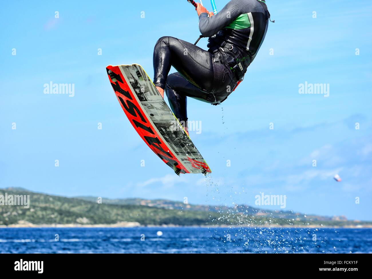 Jumping male kitesurfer - Porto Pollo near Palau, Province Olbia-Tempio, northen Sardinia, Italy Stock Photo
