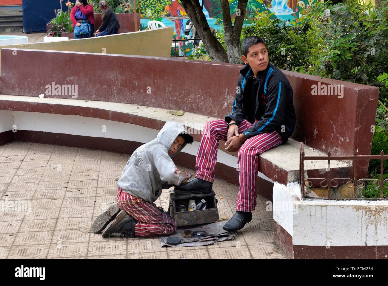 Shoe-shiner boy working in a street of Todos Santos Cuchumatan, Guatemala, Central America. Stock Photo