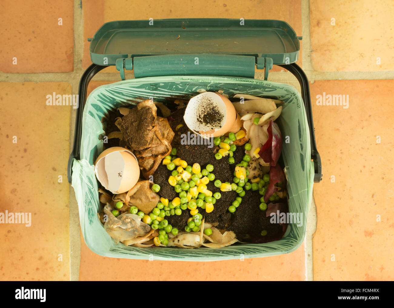 food waste - indoor food recycling caddy full of kitchen waste for recycling or composting Stock Photo