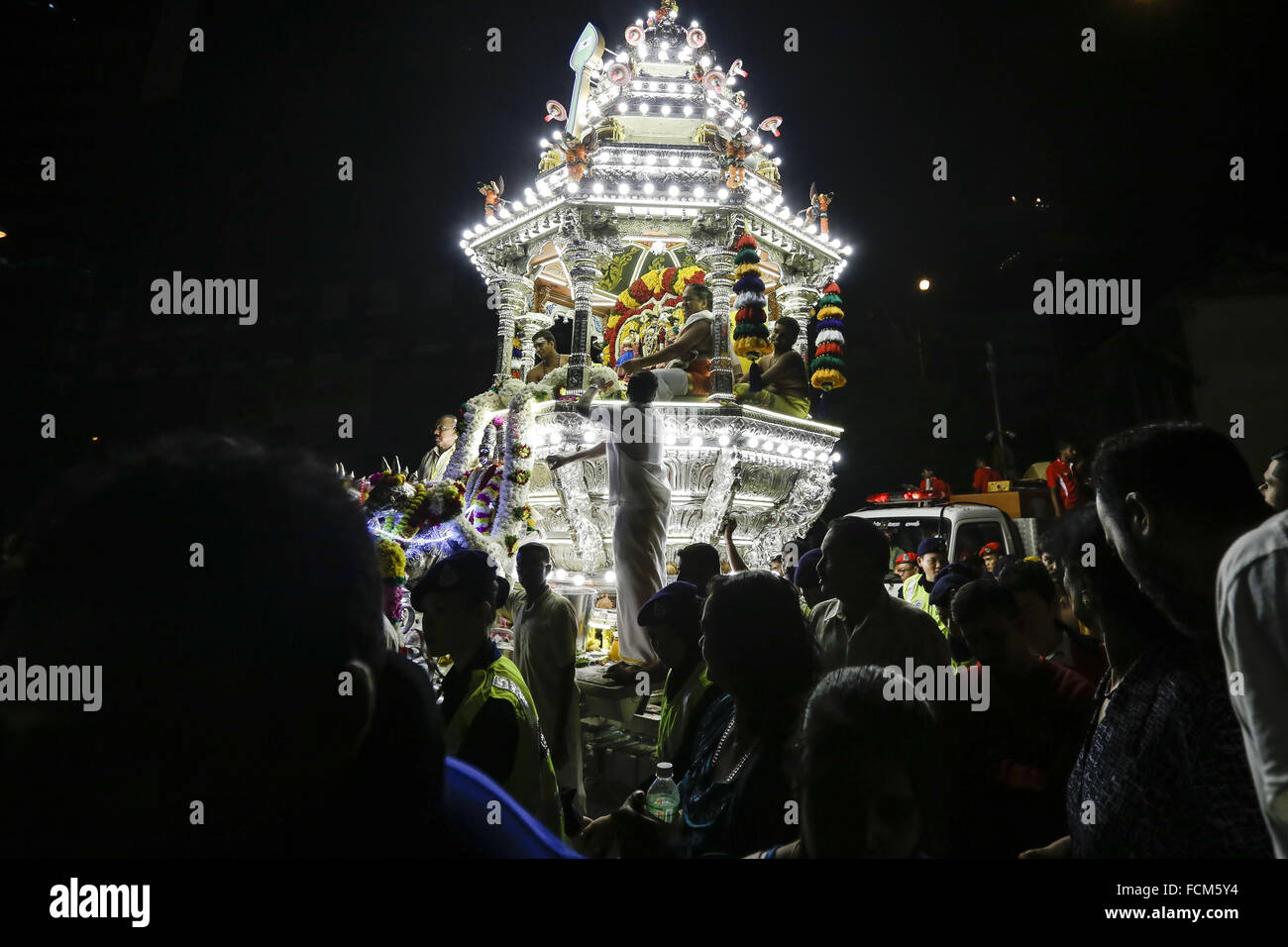 Kl, KL, Malaysia. 22nd Jan, 2016. Malaysian Hindu devotees gather around the chariot carrying a statue of Lord Murugan during a procession on the early morning of the Thaipusam festival in Kuala Lumpur, Malaysia, 23 January 2016. Devotees will gather in a large group and walk to the main temple at Batu Cave with the chariot during the Thaipusam festival to fulfill their vows and offer thanks to Lord Murugan. © Mohd Hafiz/ZUMA Wire/Alamy Live News Stock Photo