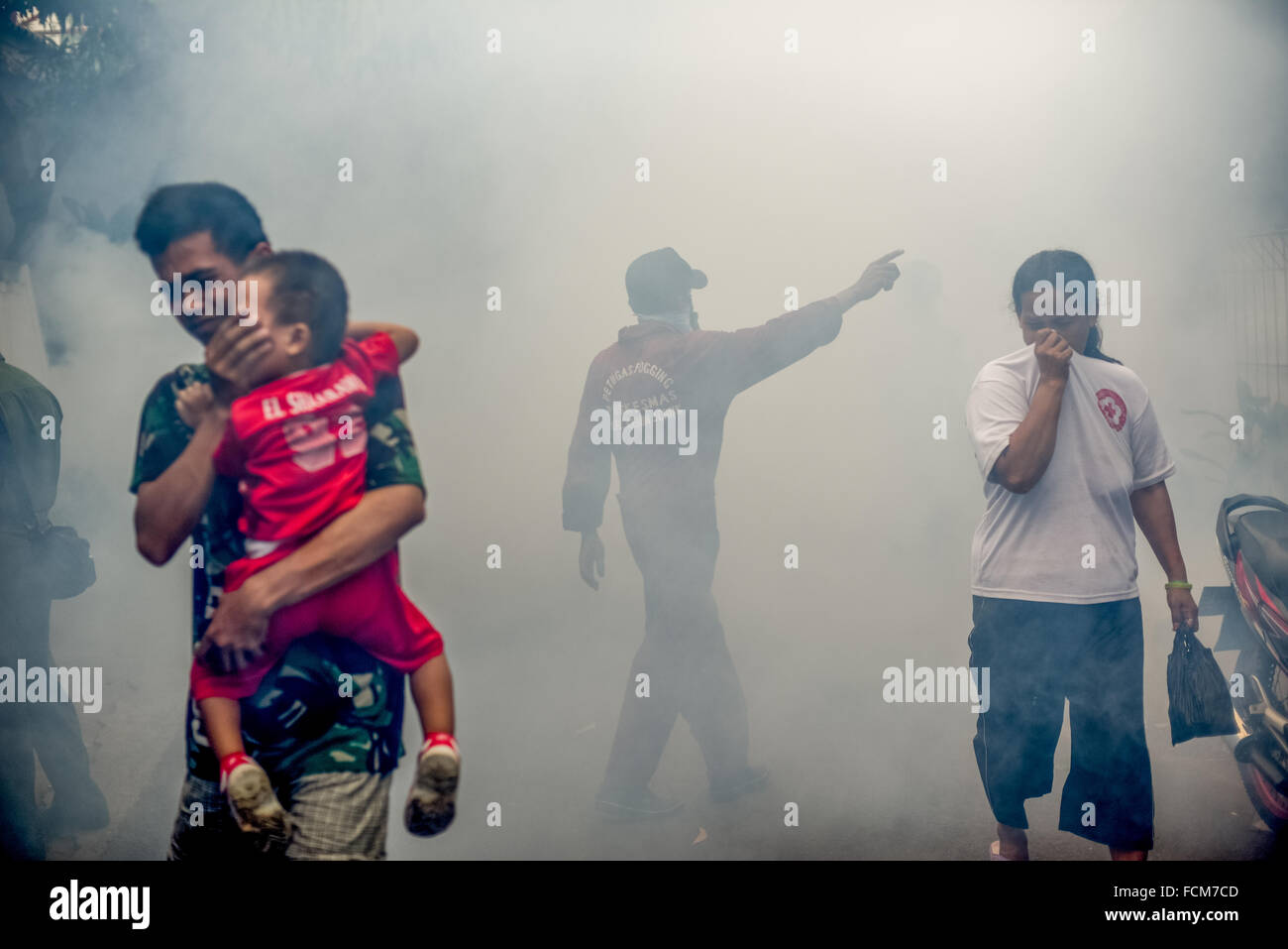 Workers from the Jakarta health office launch insecticide fogging session to fight dengue fever threat. Stock Photo