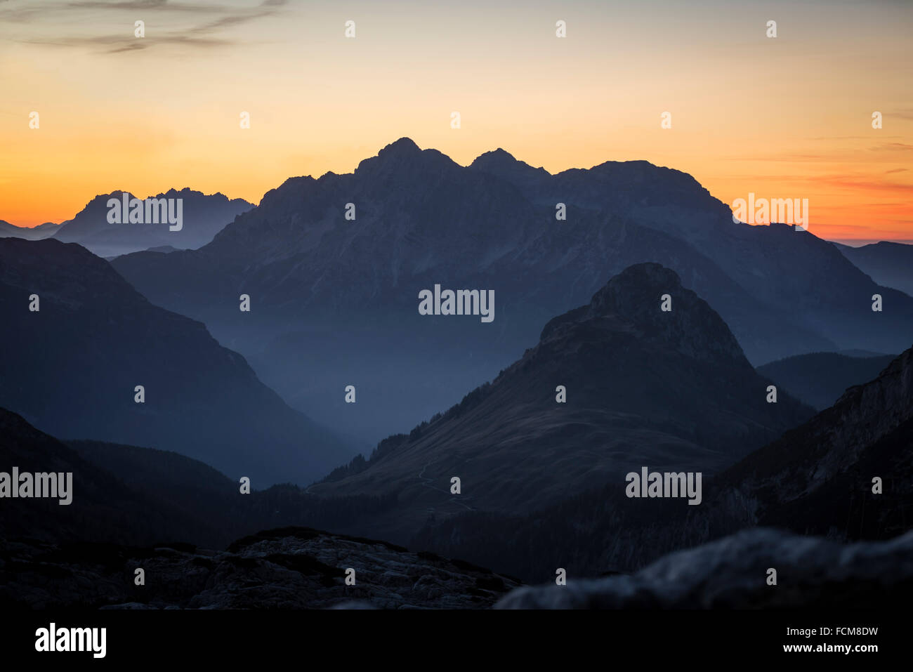 Late autumn dusk on alpine pastures and the Austrian mountain cliffs and peaks with Kallbrunnalm and Loferer Steinberge Stock Photo