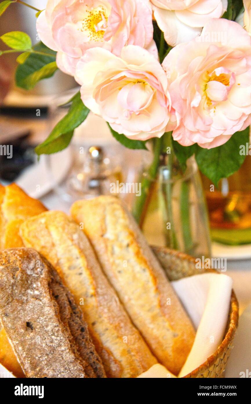 Pink roses on table restaurant Teruel Spain. Bread basket Stock Photo