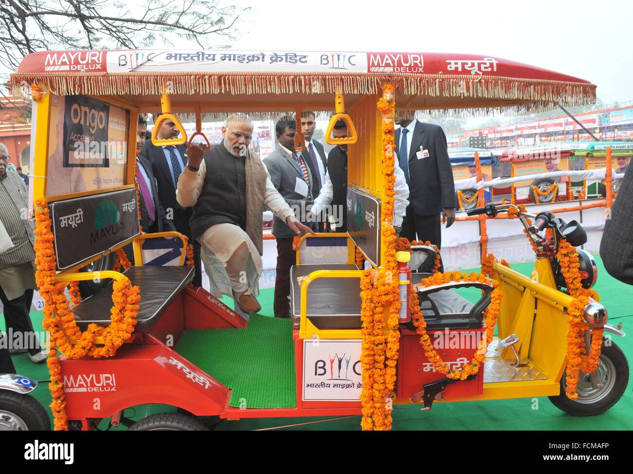 Indian Prime Minister Narendra Modi steps into the newly developed ERickshaw, the all electric