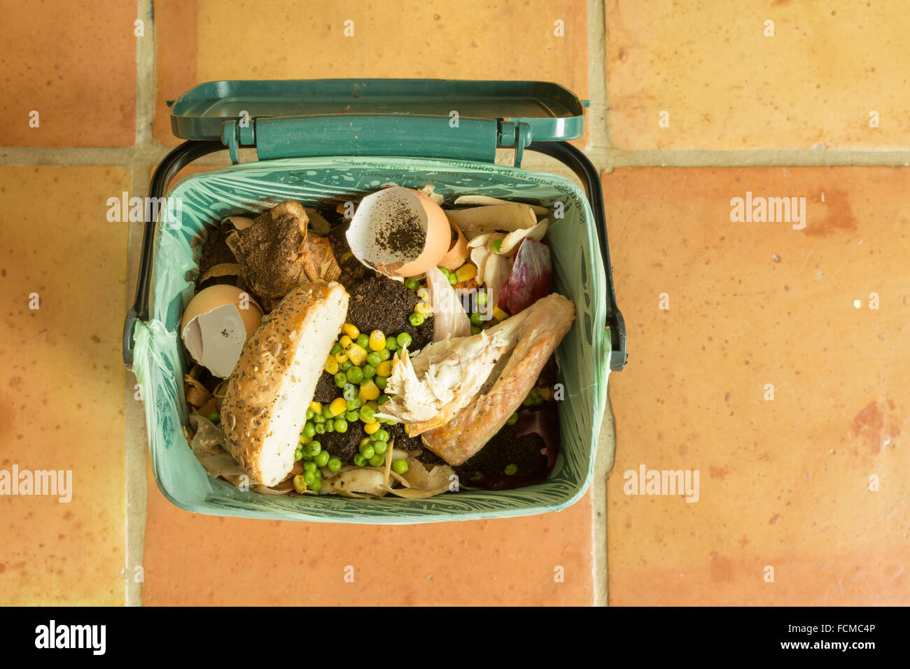 food waste - Indoor food recycling caddy full of kitchen waste including meat and bread Stock Photo