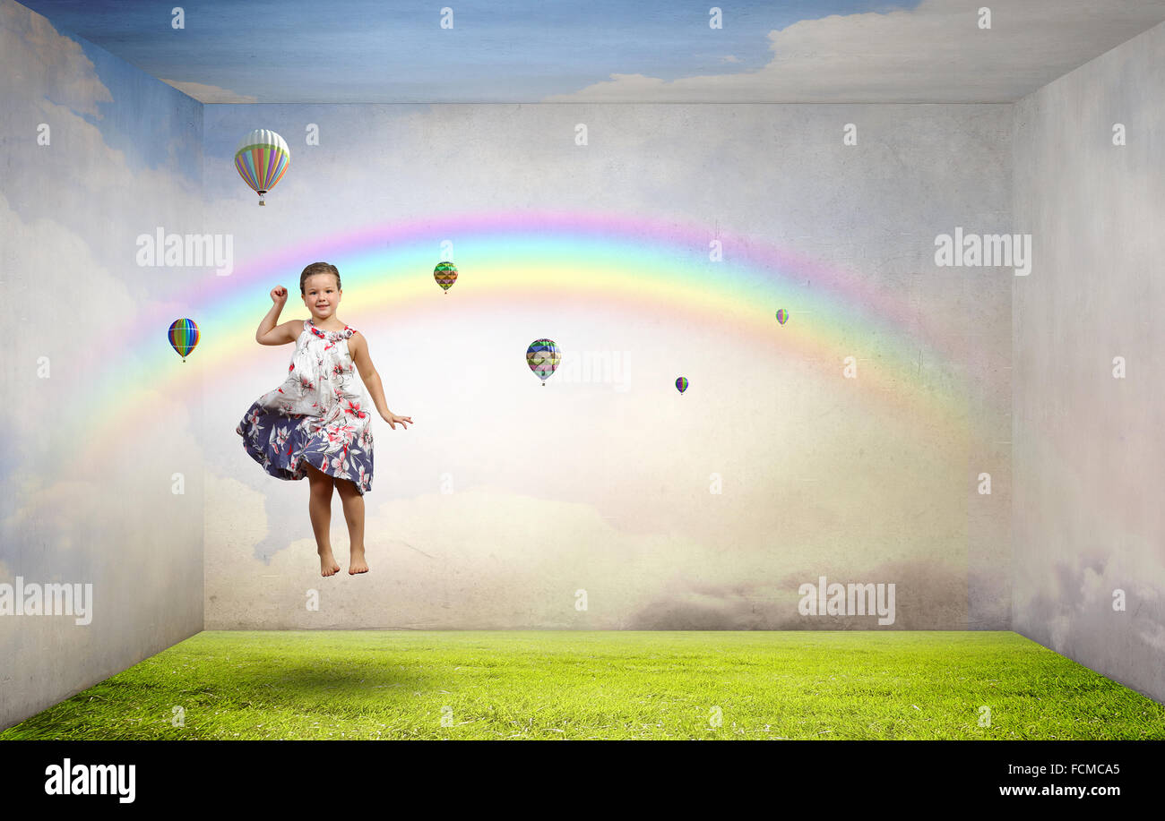 Little cute girl jumping high among balloons flying in sky Stock Photo ...