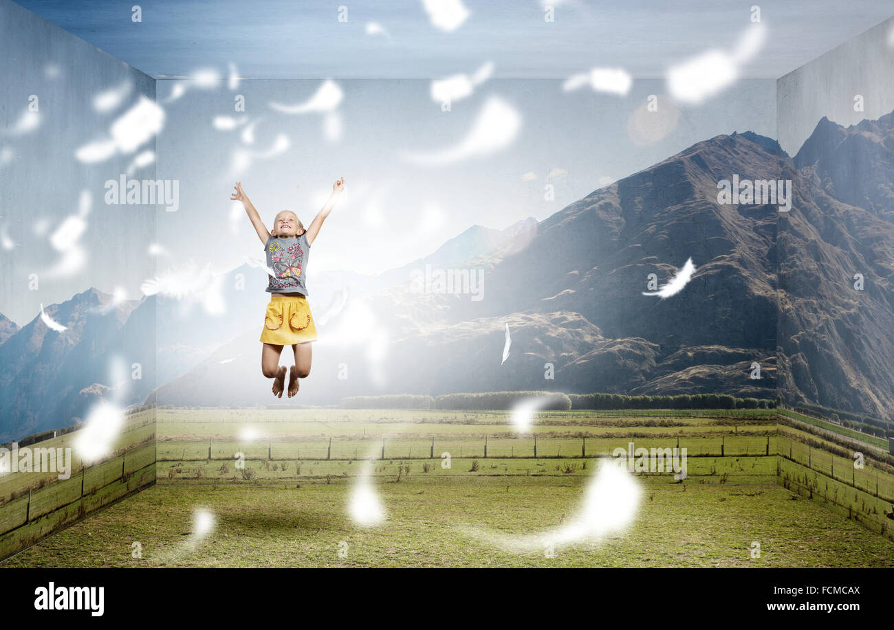 Little cute girl jumping high among feathers flying in sky Stock Photo ...