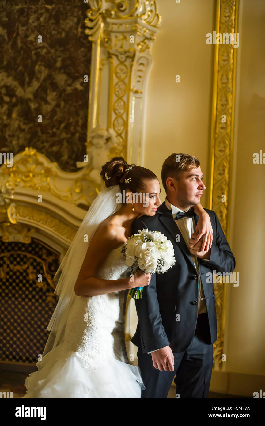 Newlyweds are standing in wedding palace Stock Photo - Alamy