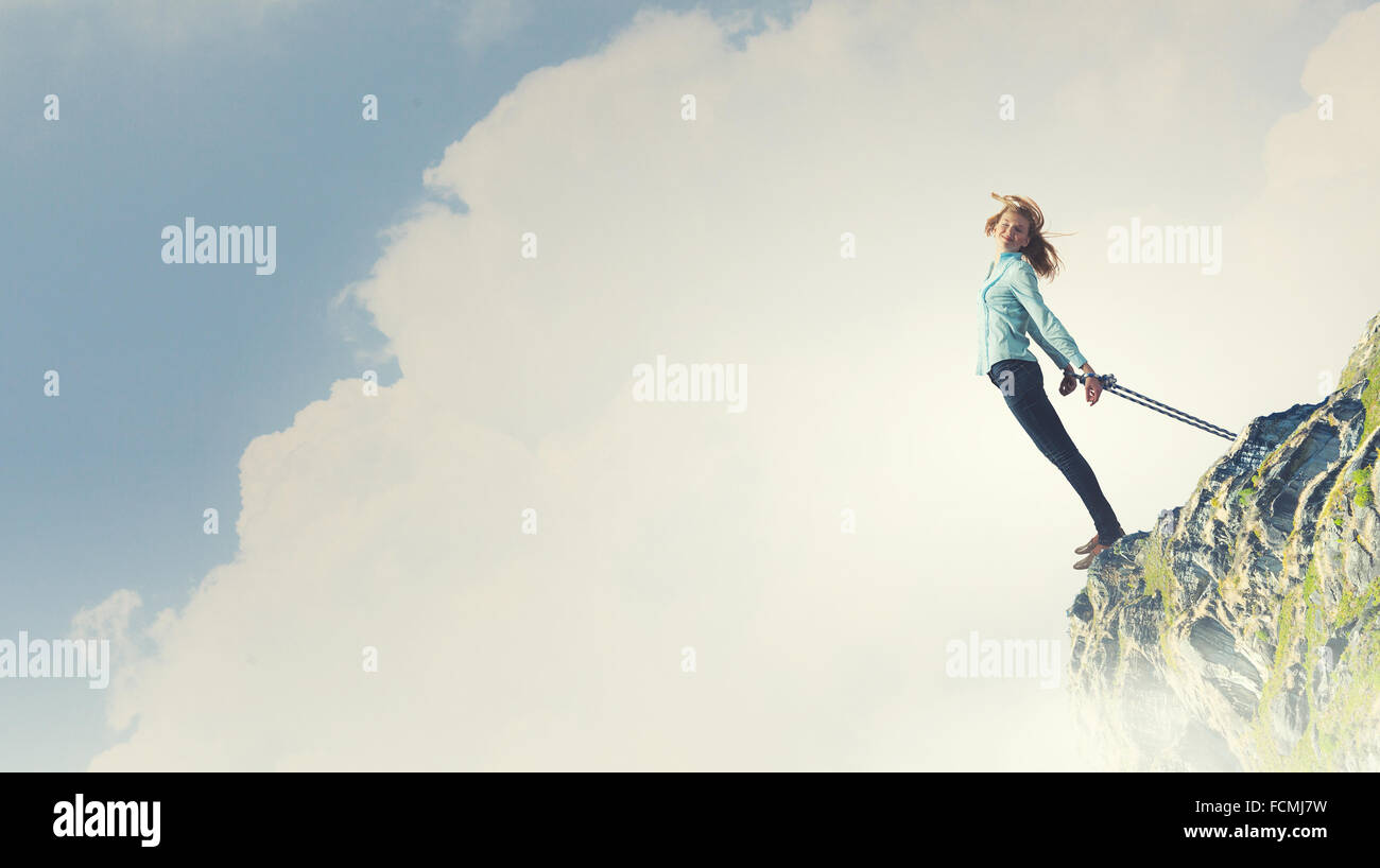 Young girl with ropes on hands trying to fly Stock Photo - Alamy