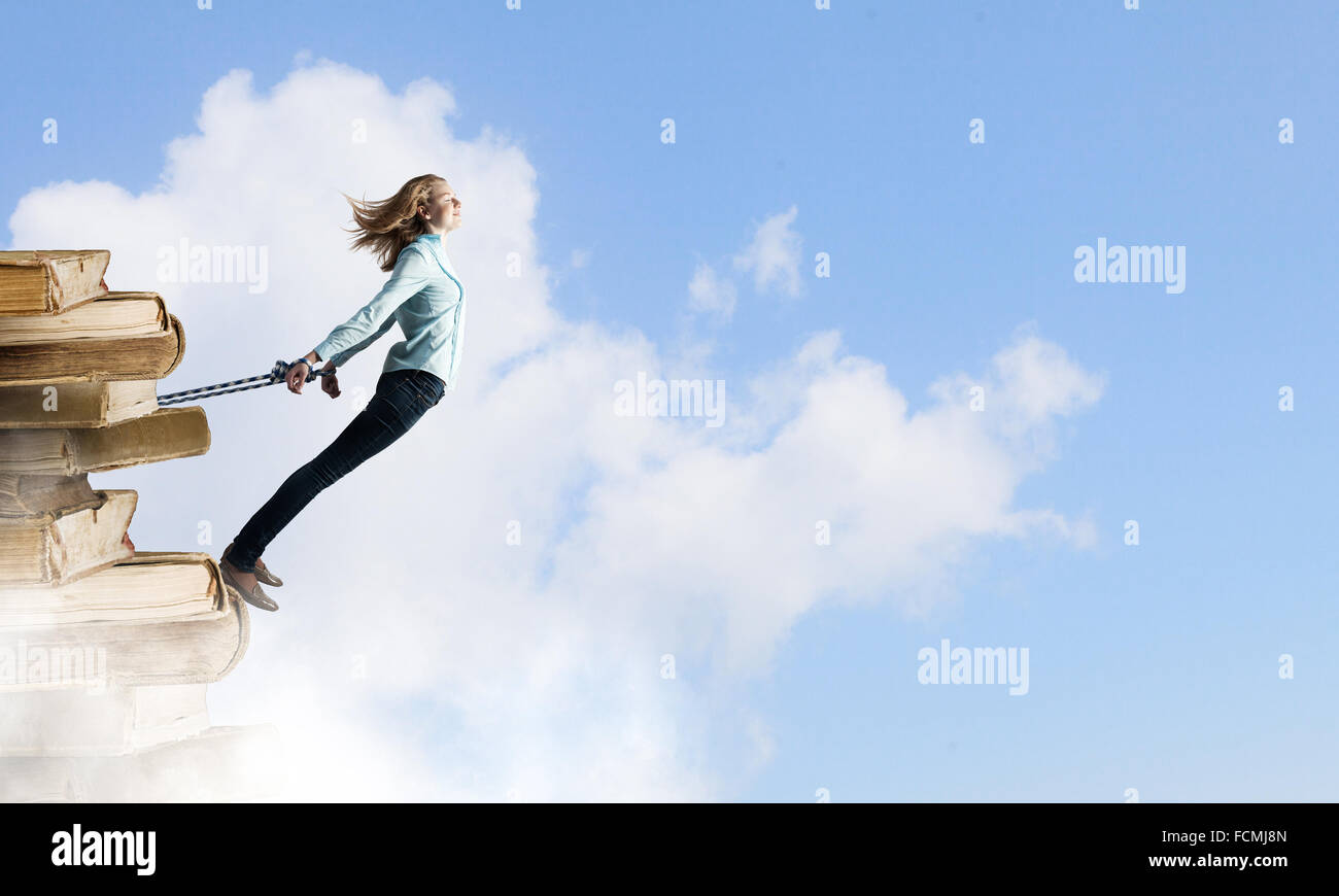 Young girl with ropes on hands trying to fly Stock Photo - Alamy