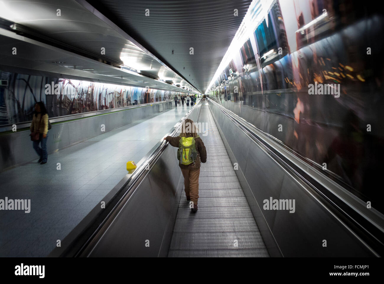 Young girl using the walkway between terminals at Frankfurt Airport, Germany. Stock Photo