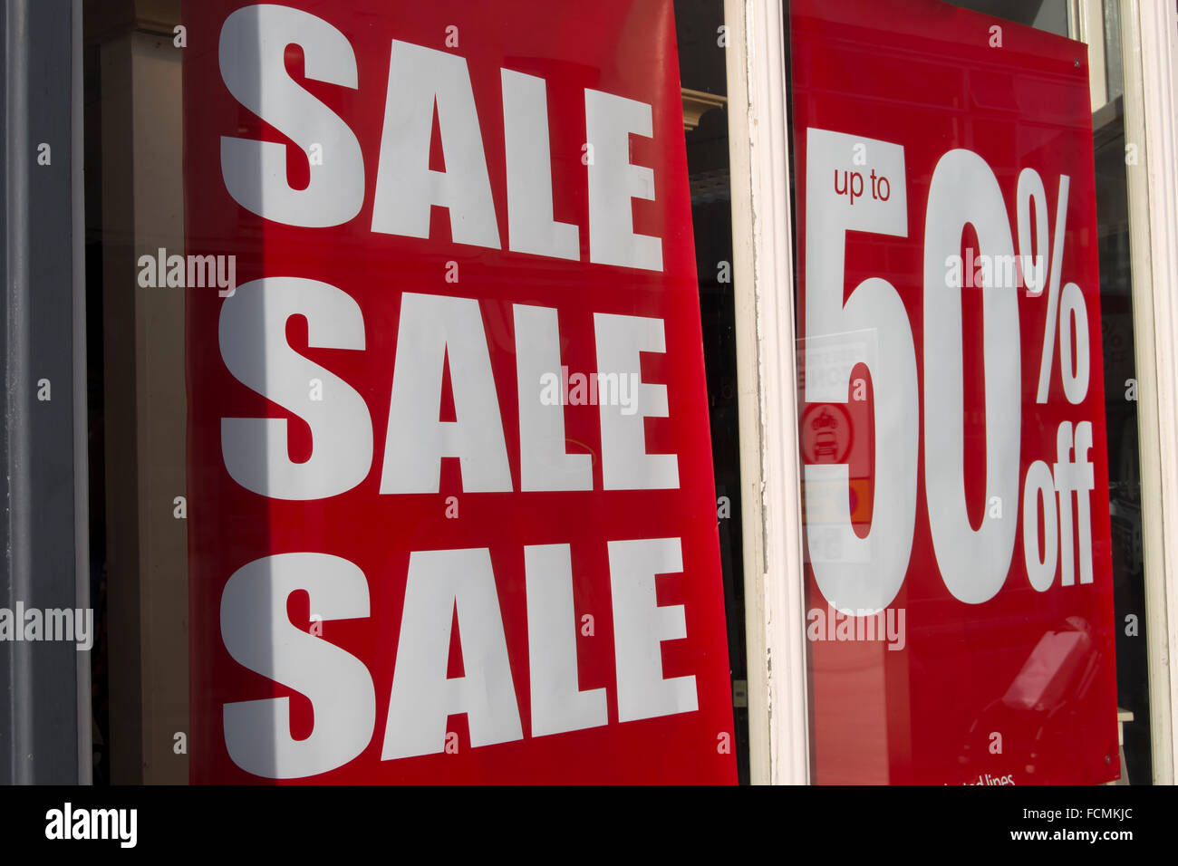 sale and up to 50 percent off sign in shop window in kingston upon thames, surrey, england Stock Photo