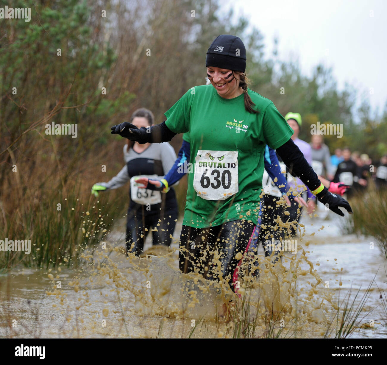 Aldershot, Hants, UK. 23rd January, 2016.  Daniella Barnett makes her way through the flooded streams of the Brutal women only  10km  race at Long valley Aldershot Hampshire having to break the ice as the make there way around the course .  The recent weather made the Brutal 10km off road course live up to its name as the puddles and streams where up to waste height in many places with early runners having to break the ice as they entered the water.  Credit:  PBWPIX/Alamy Live News Stock Photo