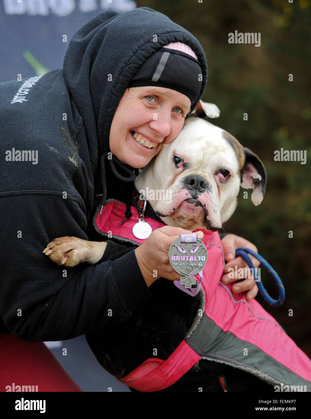 Aldershot, Hants, UK. 23rd January, 2016. Jools and Phoebe Pocknell celebrate with their medal after completing the 5KM canicross Brutal women  race at Long valley Aldershot Hampshire.  The recent weather made the Brutal 10km off road course live up to its name as the puddles and streams where up to waste height in many places with early runners having to break the ice as they entered the water.  Credit:  PBWPIX/Alamy Live News Stock Photo