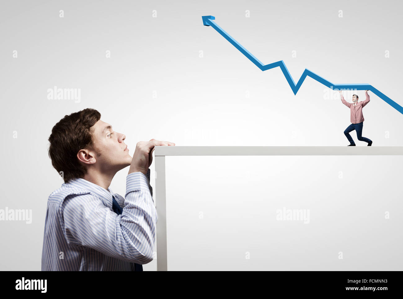 Half face of businessman looking from under table Stock Photo - Alamy