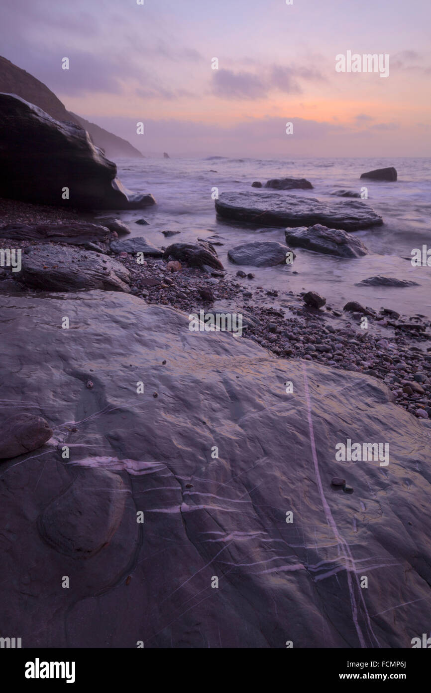 Dawn breaking over Downderry beach in south east cornwall Stock Photo