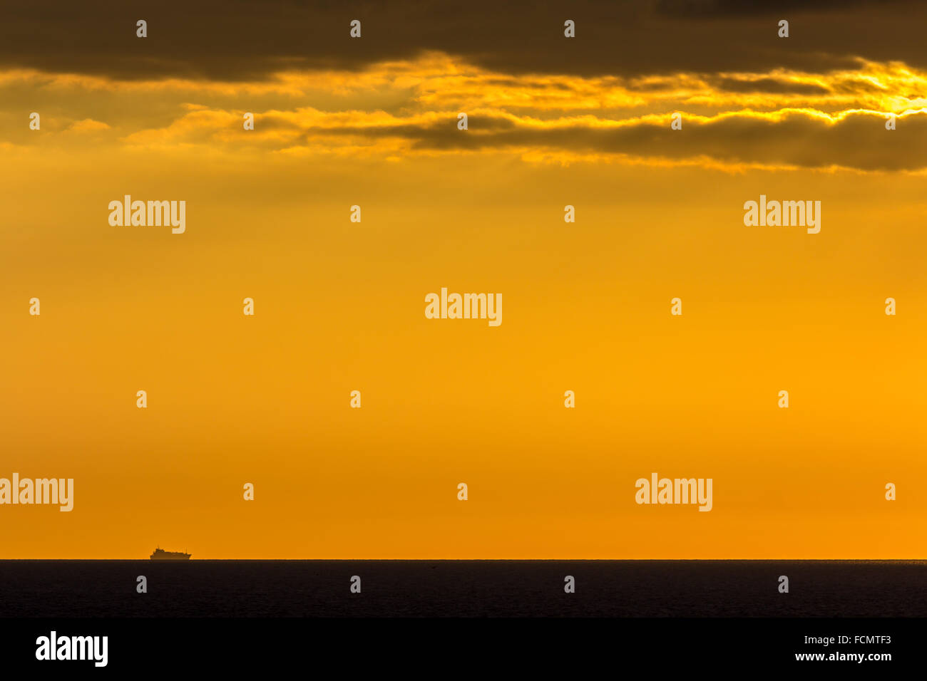 Ship on the horizon Stock Photo - Alamy