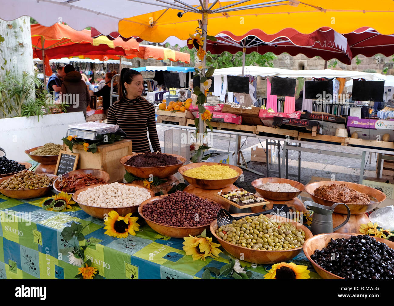 Olive stall and stallholder in the market at Fréjus, South of France. Stock Photo