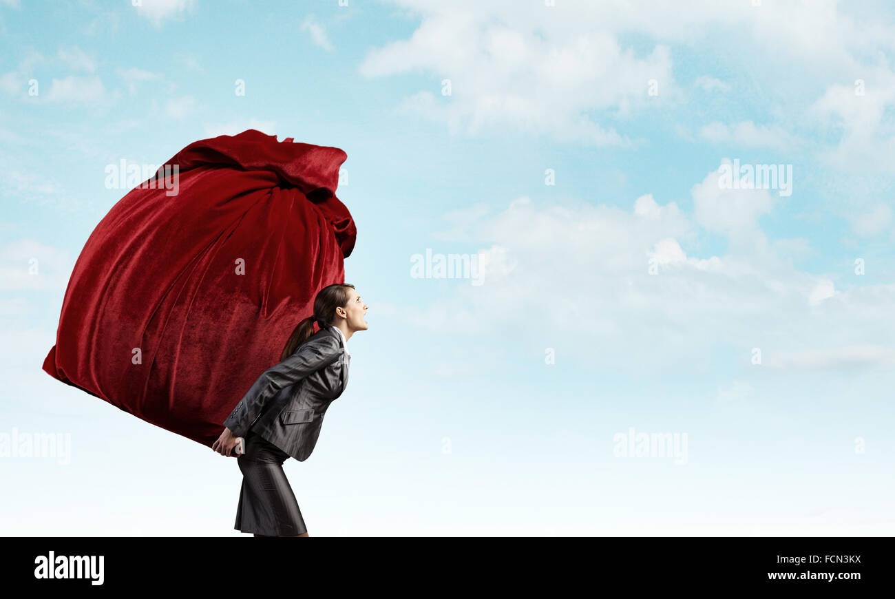 Businesswoman carrying big red bag on back Stock Photo Alamy