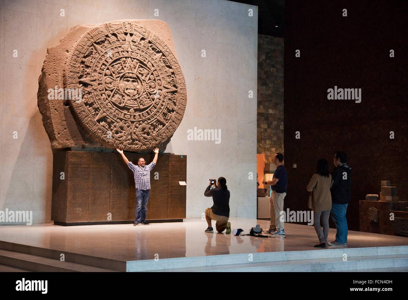 Tourists in front of the Calendario Azteca or Piedra del Sol at the Museo Nacional de Tourists in front of the Calendario Azteca or Piedra del Sol at the Museo Nacional de