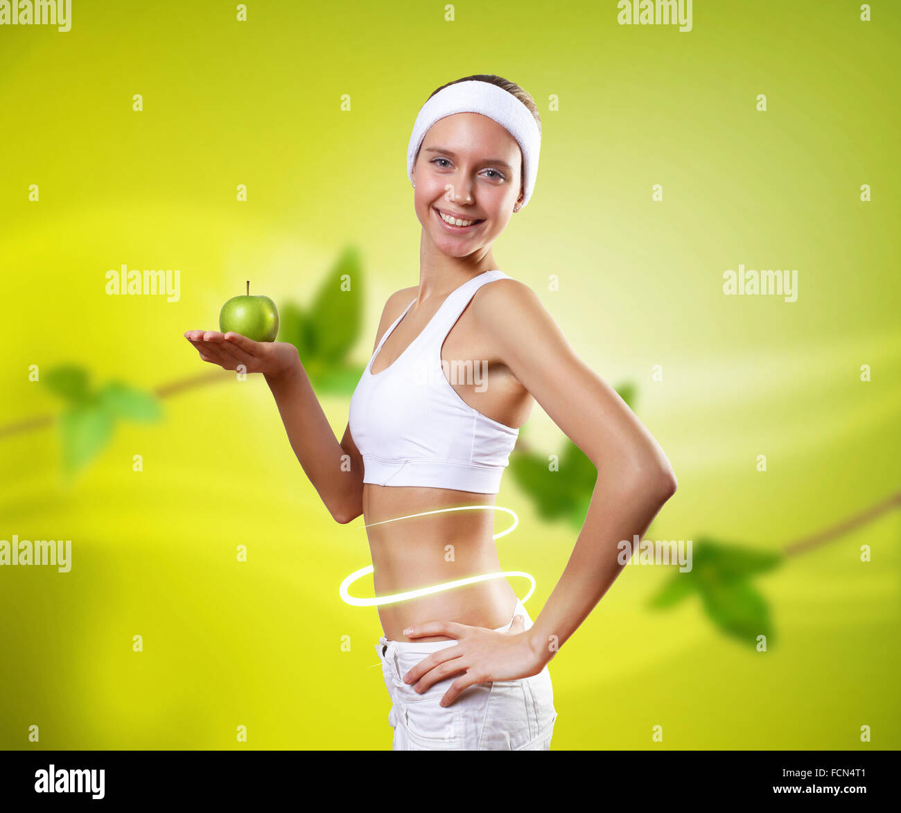 Young pretty girl in sport wear with green apple Stock Photo - Alamy