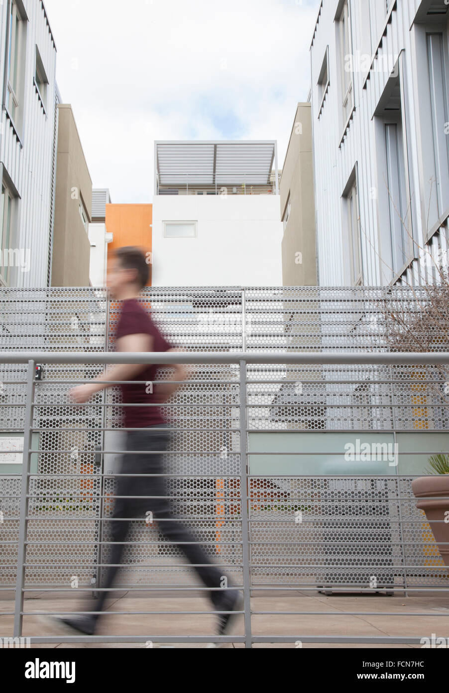 Man rushes in urban city dwelling Stock Photo