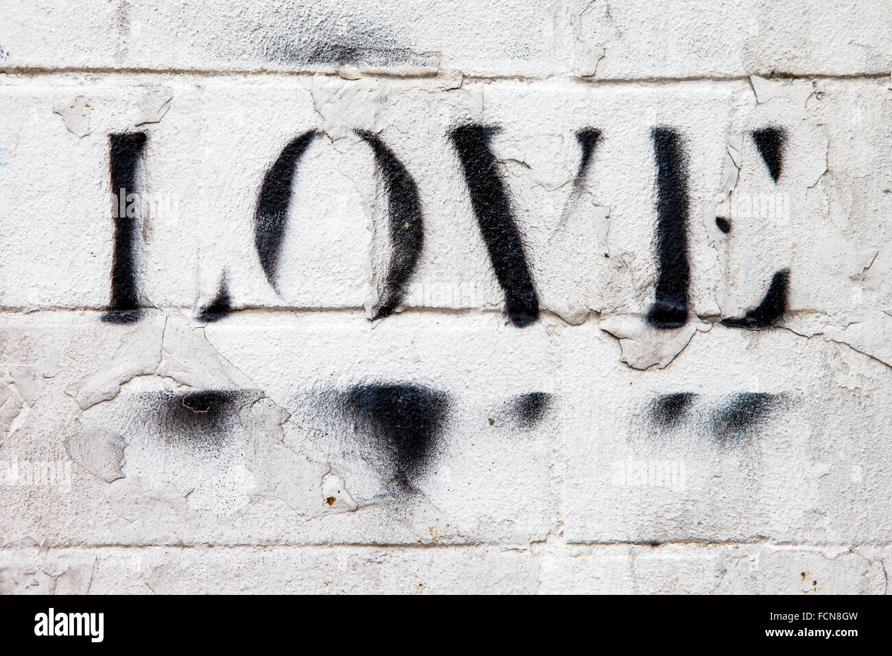 LONDON, UK - JANUARY 13TH 2016: The word LOVE sprayed onto a brick wall in London, on 13th January 2016. Stock Photo