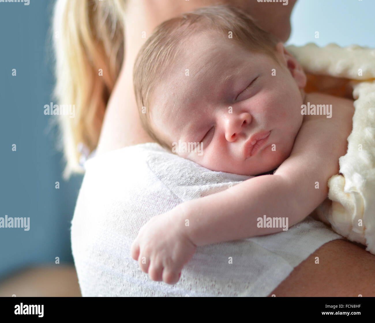 Mother holding sleeping newborn child Stock Photo