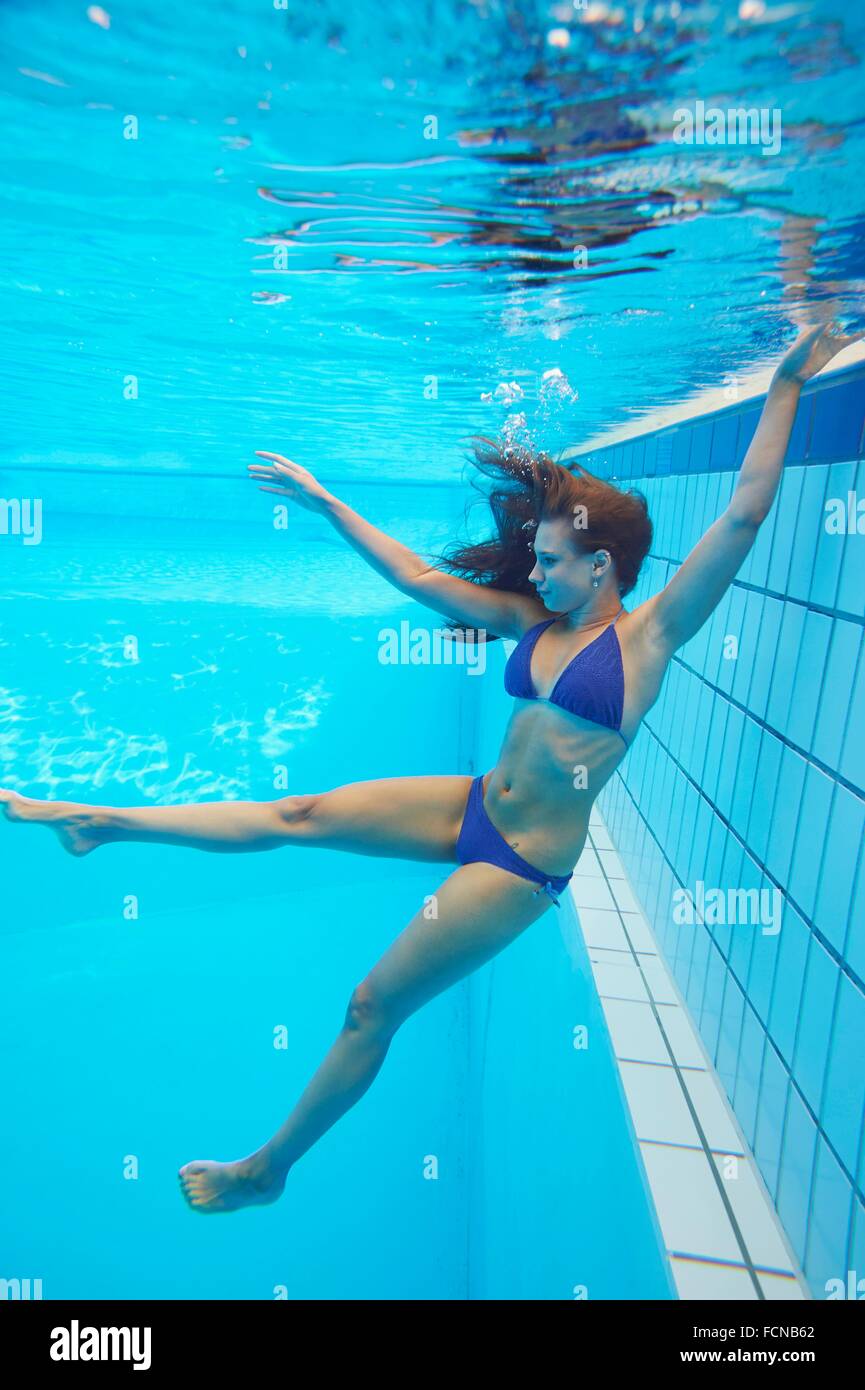 once Police station Mottle Young woman wearing a bikini while swimming under water in a open-air pool  Stock Photo - Alamy