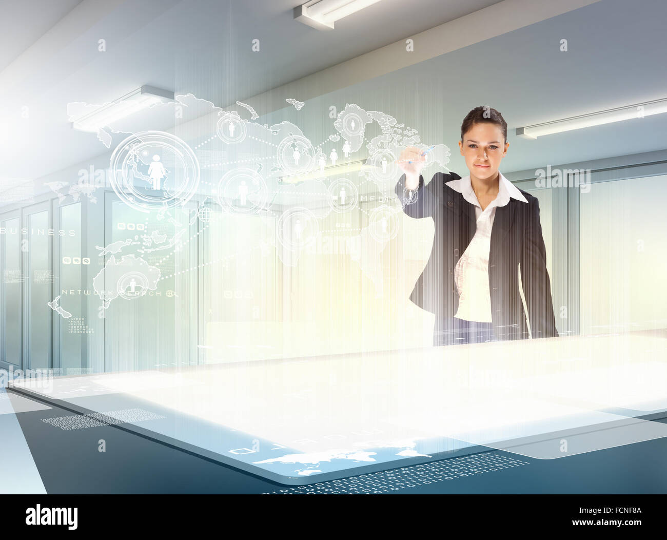 Image of young businesswoman clicking icon on high-tech picture Stock Photo