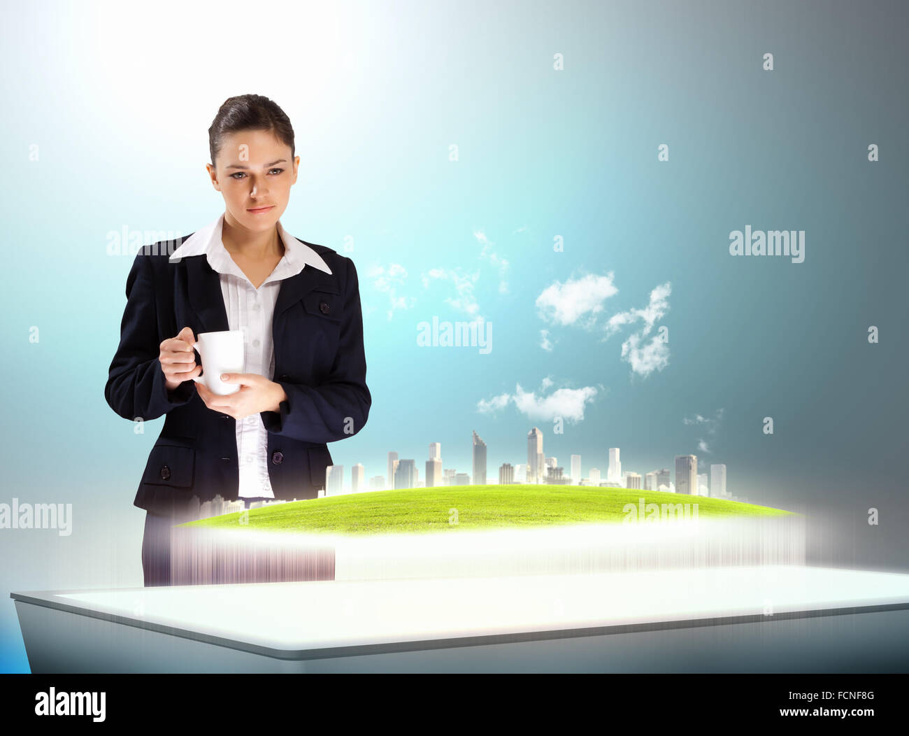 Image of young businesswoman holding cup standing against high-tech picture Stock Photo
