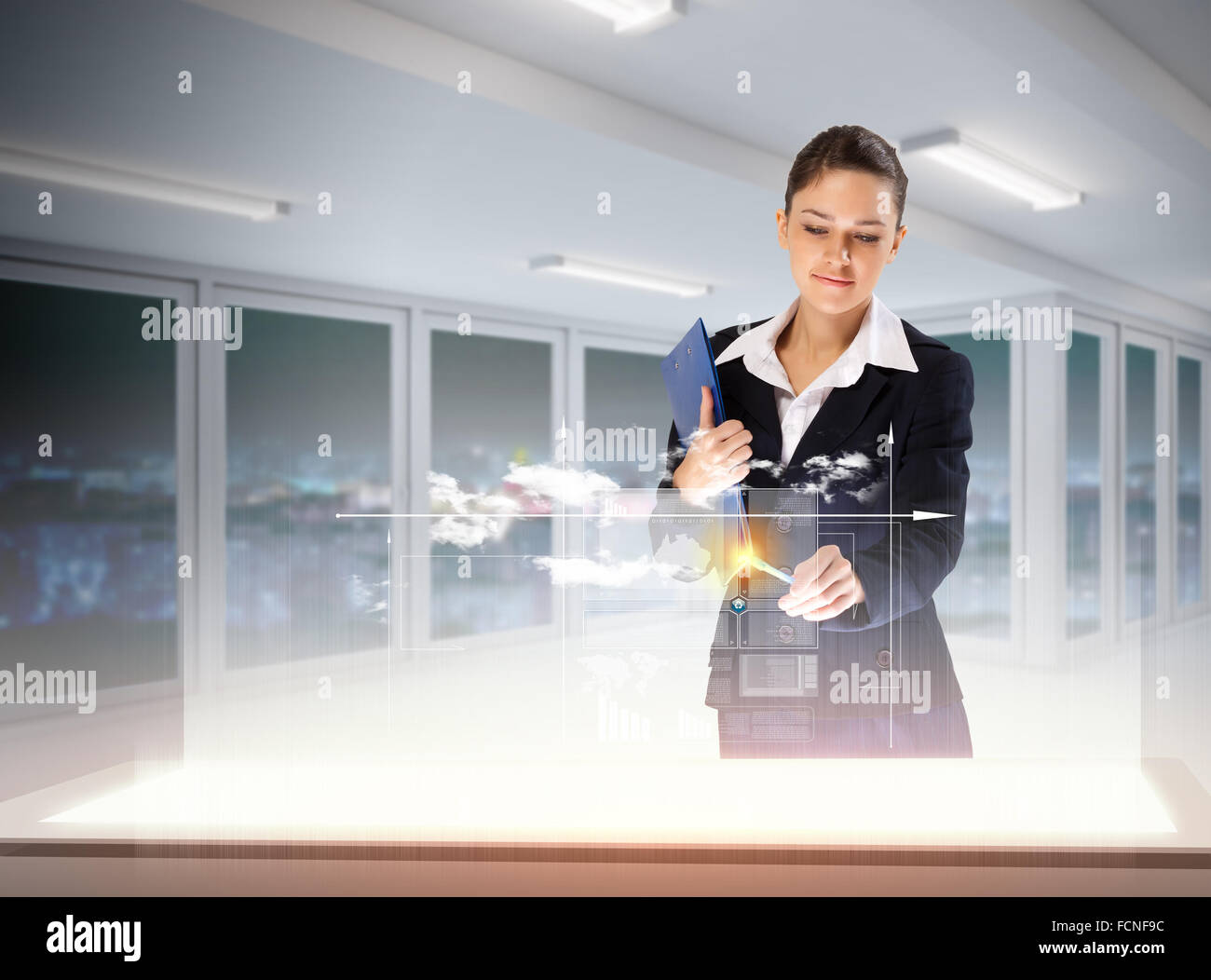 Image of young businesswoman clicking icon on high-tech picture Stock Photo