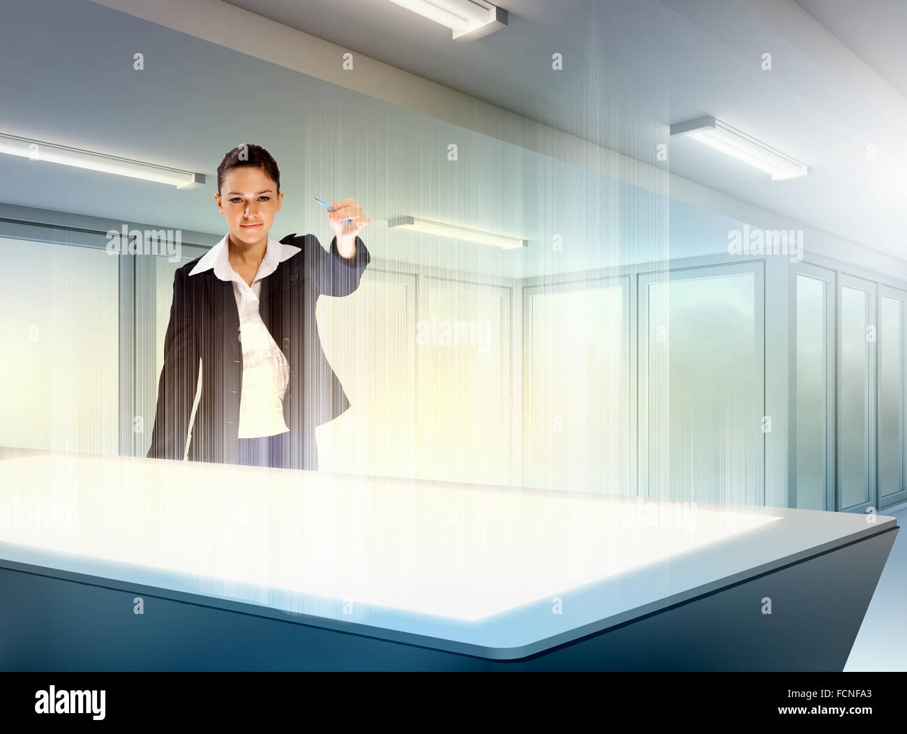 Image of young businesswoman clicking icon on high-tech picture Stock Photo