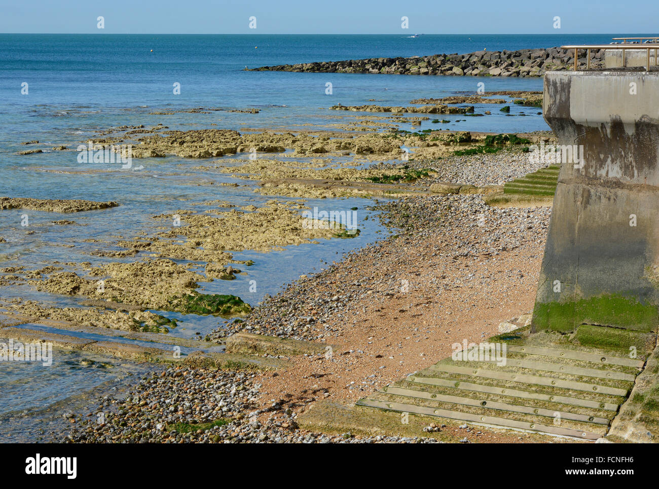 Shingle beach and rocks at low tide between Brighton Marina and