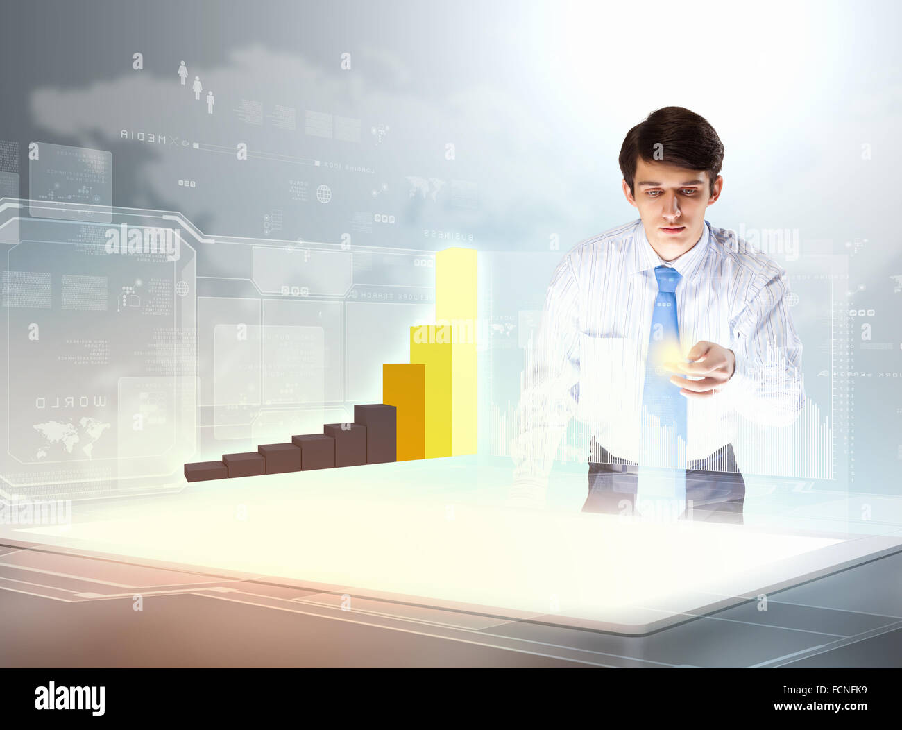 young businessman looking at graph of high-tech image Stock Photo