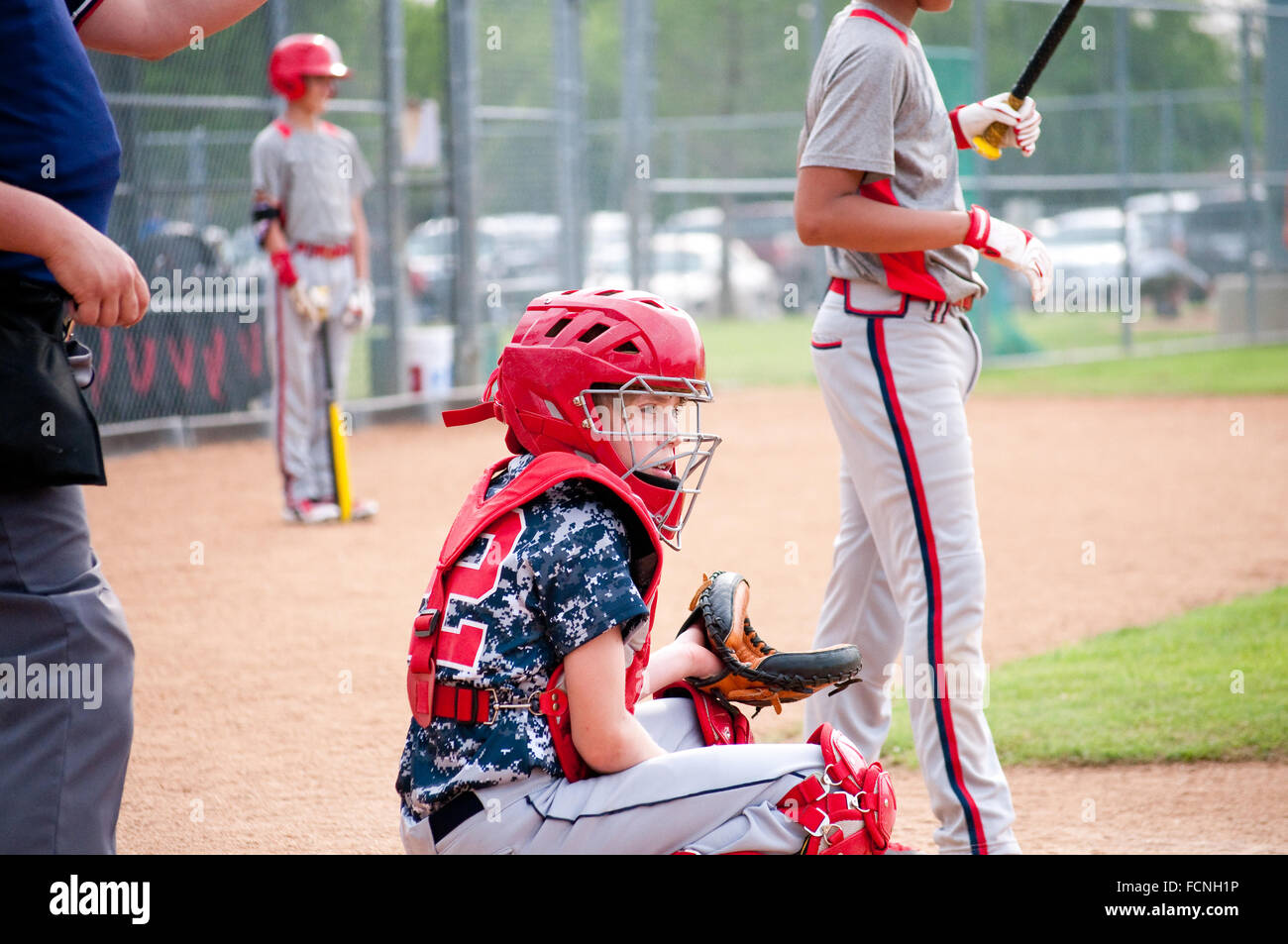 Young baseball boy catcher getting signals from coach with referee Stock Photo Alamy