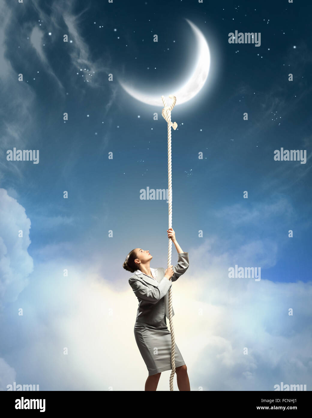 Image of businesswoman climbing the rope to the moon Stock Photo - Alamy