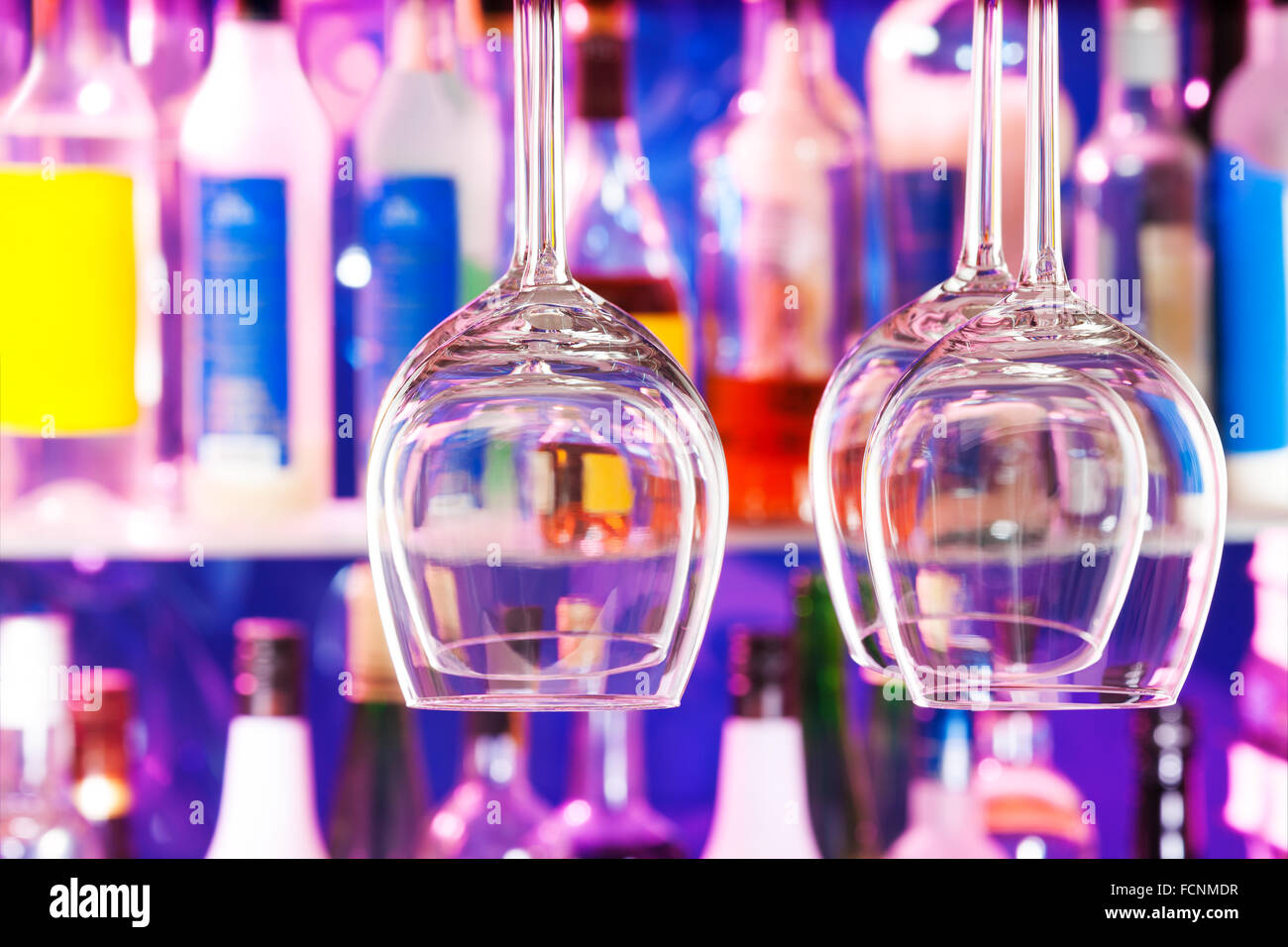 Some wine glasses on hanger in bar Stock Photo