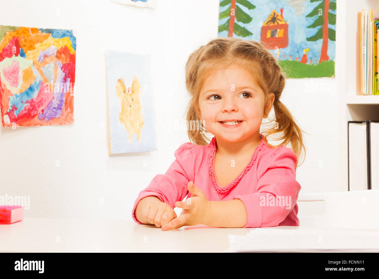 Cute little girl doing her lessons at the desk Stock Photo