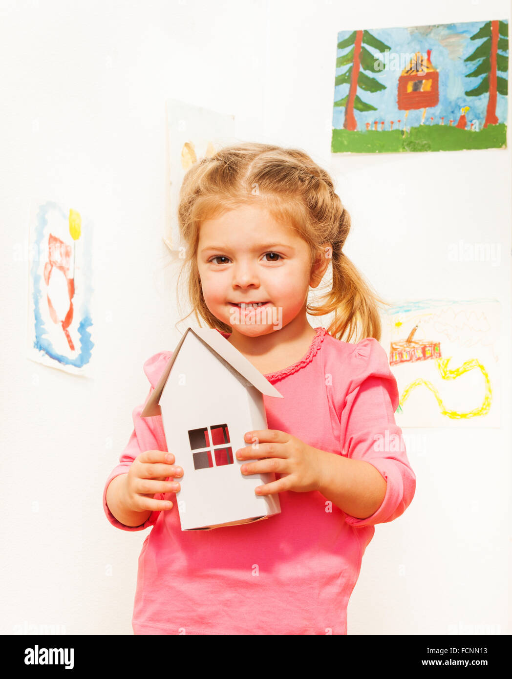 Beautiful girl with cardboard white doll house Stock Photo