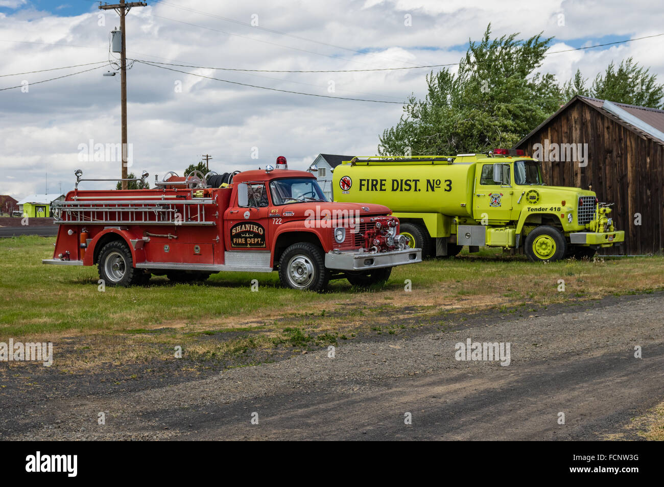 Two vintage fire trucks in the ghost town of Shaniko in eastern Oregon, USA Stock Photo