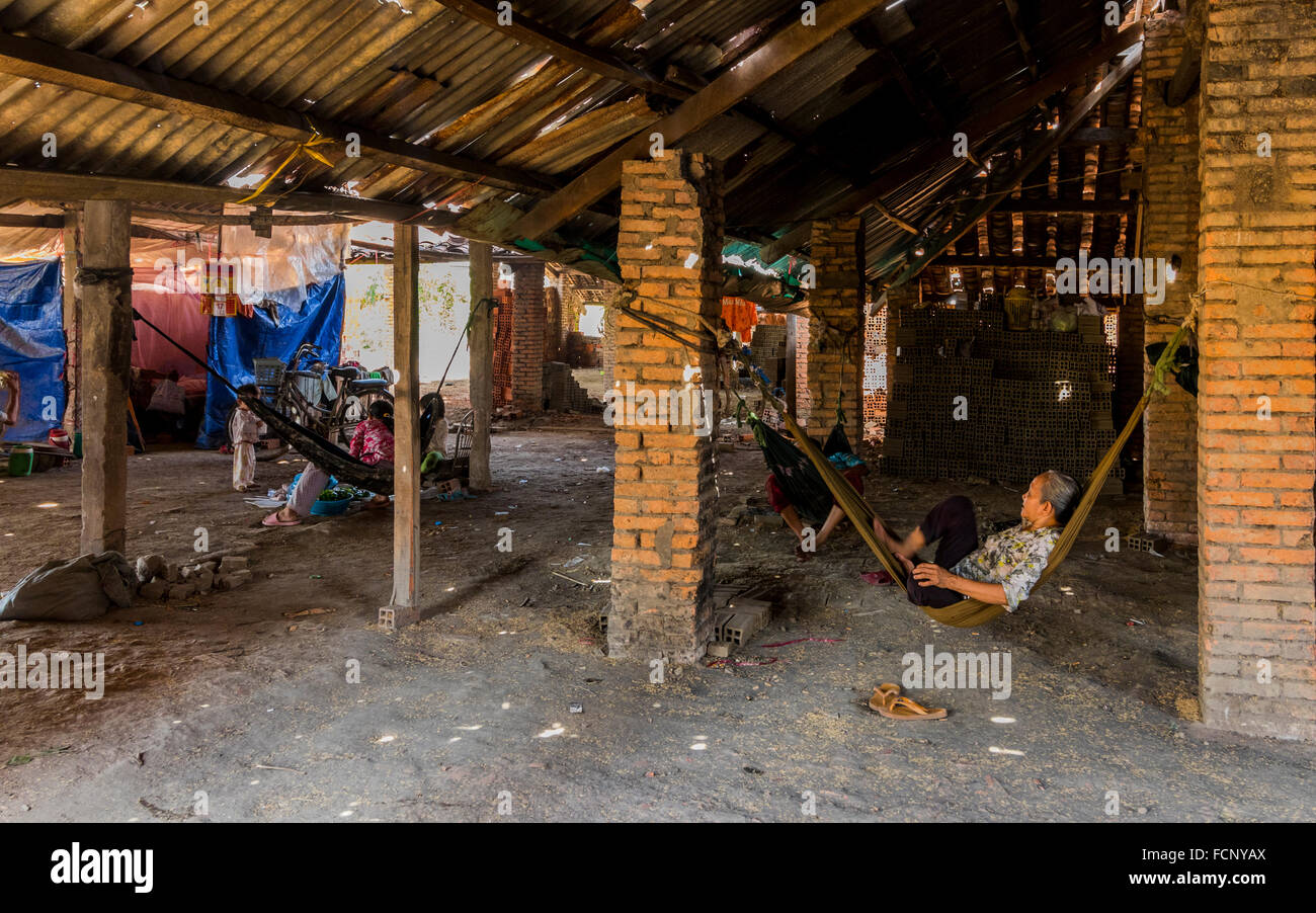 Small brickworks on the Mekong Delta Vietnam.Families not only work in these small factories but live their too. Stock Photo