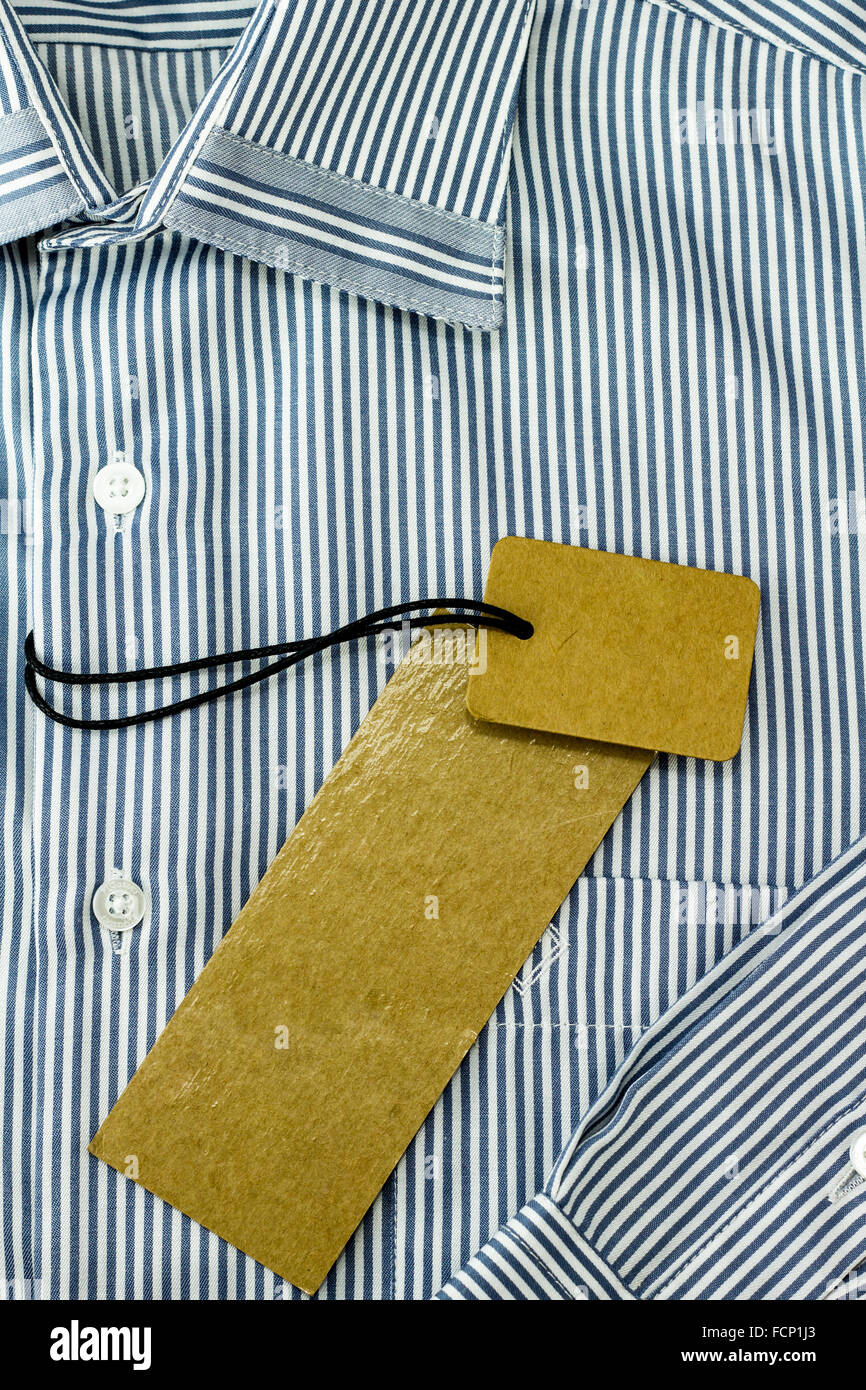 Brown tag label on white & blue shirt Stock Photo