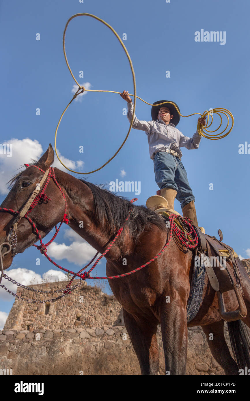 Charro Rodeo Ropes A Mexican charro or cowboy practices roping skills on his horse before ...