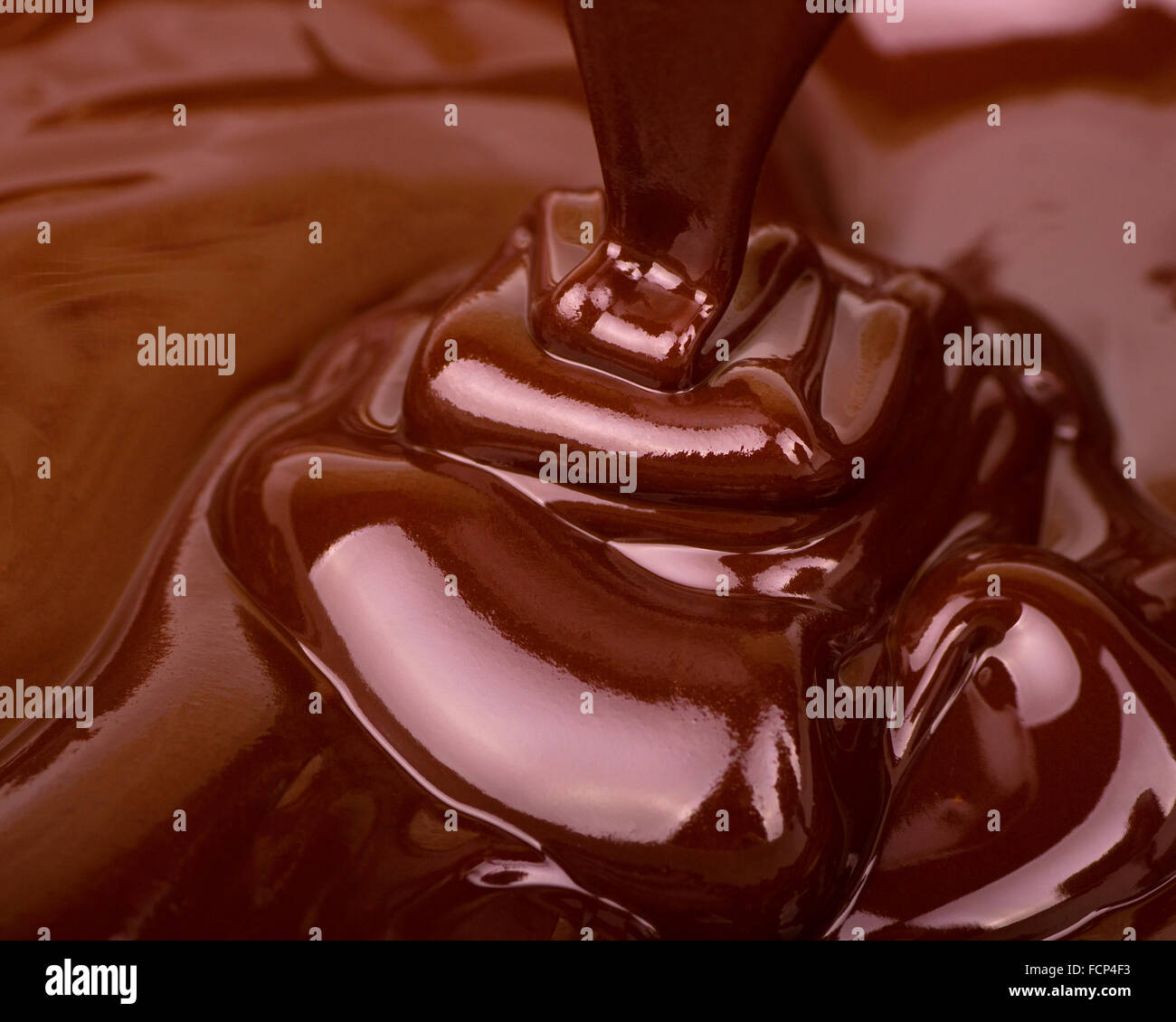 Chocolate flowing, macro photo with rich, smooth, silky texture Stock Photo