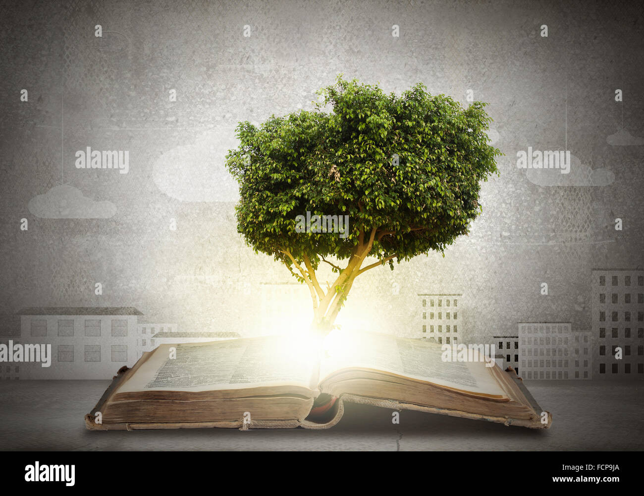 Conceptual image with green tree growing from book Stock Photo Alamy