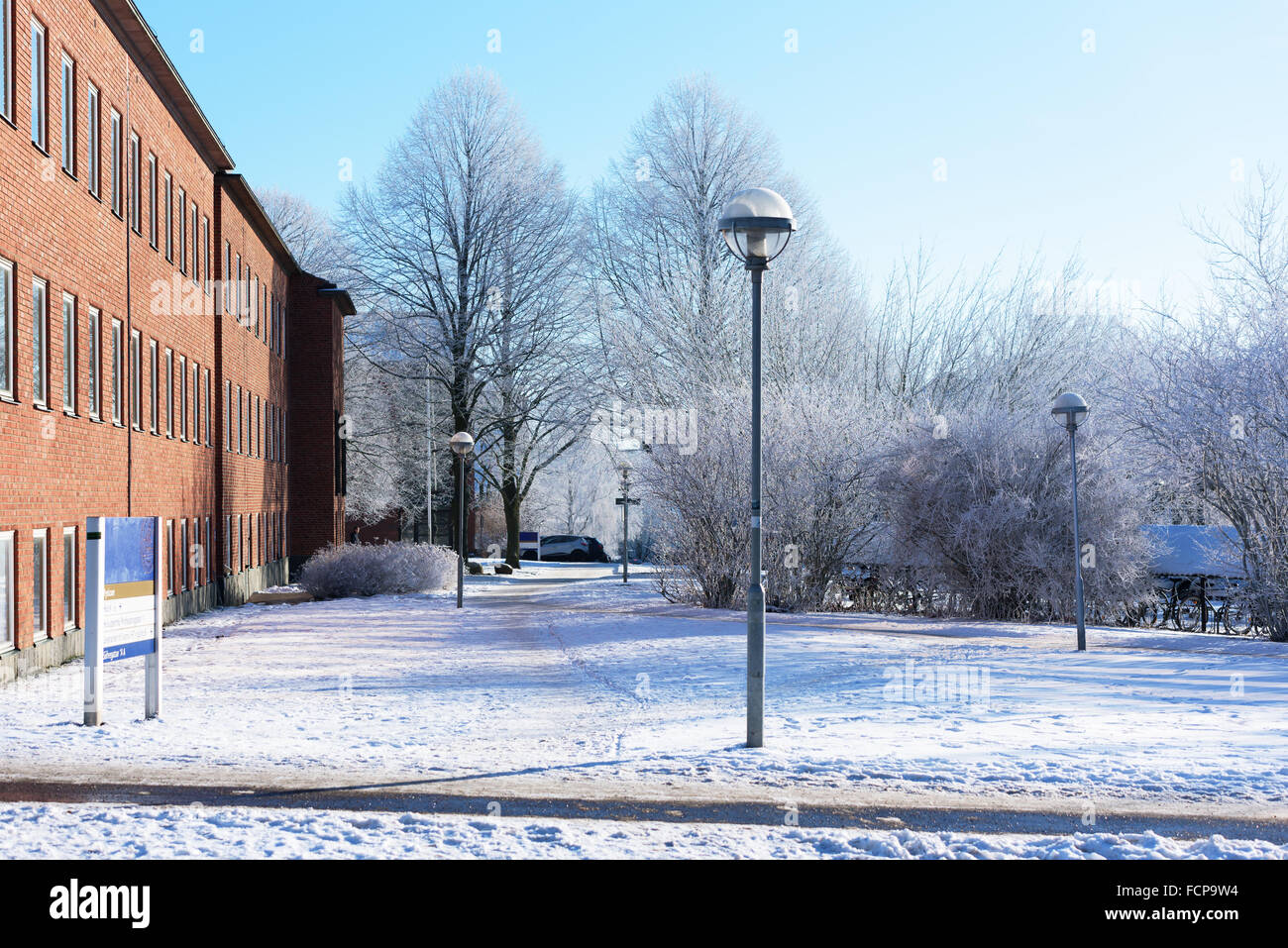 Lund, Sweden - January 21, 2016: Fine walkway past the Fysicum at Lund university. Frosty trees and shrubs together with streetl Stock Photo