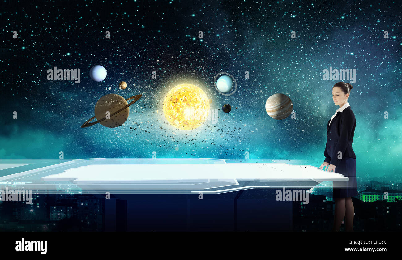 Young businesswoman and planets of space spinning around Stock Photo ...