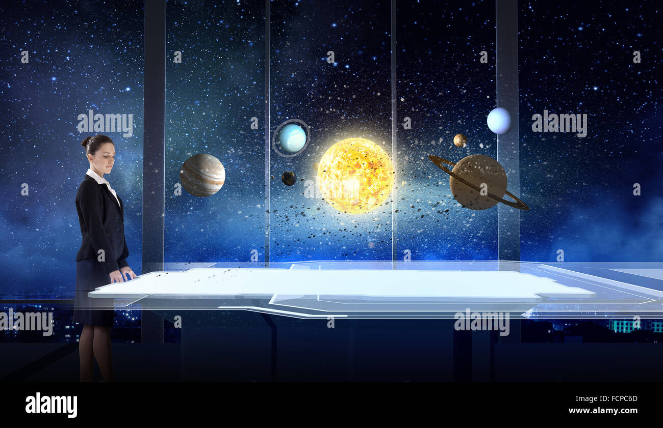 Young businesswoman and planets of space spinning around Stock Photo ...