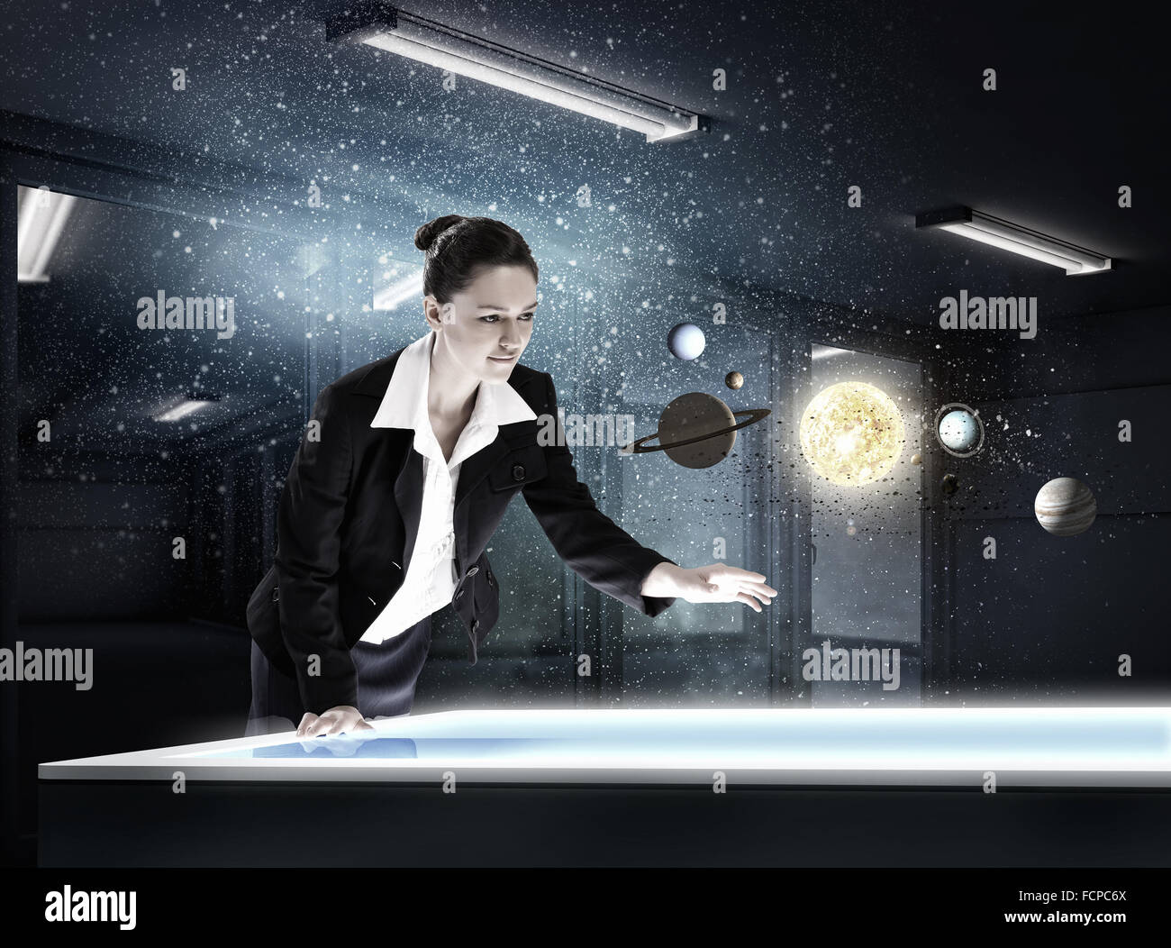Young businesswoman and planets of space spinning around Stock Photo ...